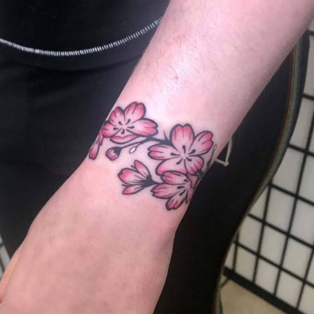 Pink Flower Wrap Around Flower Wrist Tattoos