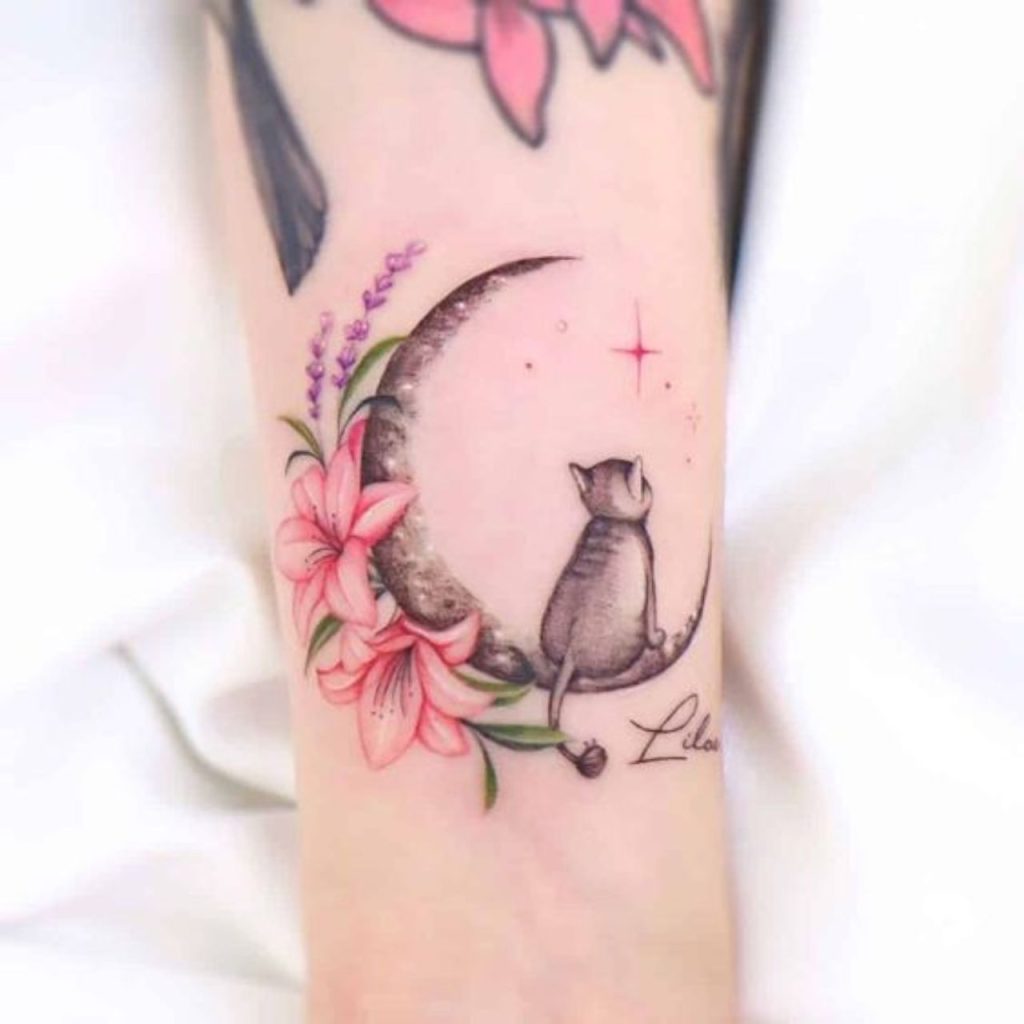 Cat sitting on the moon tattoo on the arm