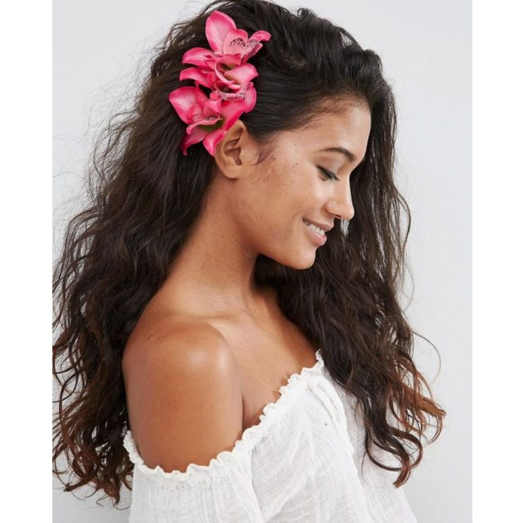 Hawaiian Long curly Hairstyle with red flowers behind the ear