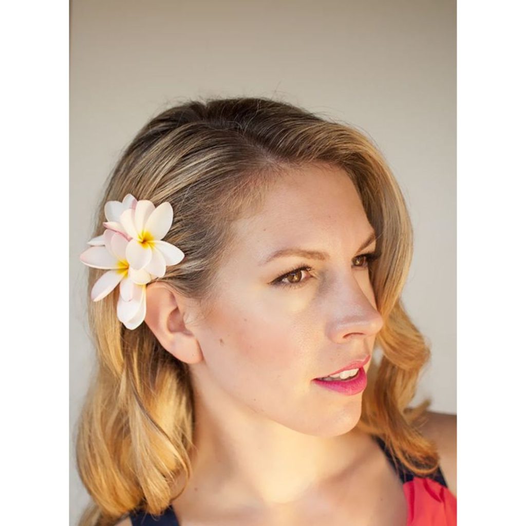 Hawaiian Blonde Hairstyle with white flower behind the ear