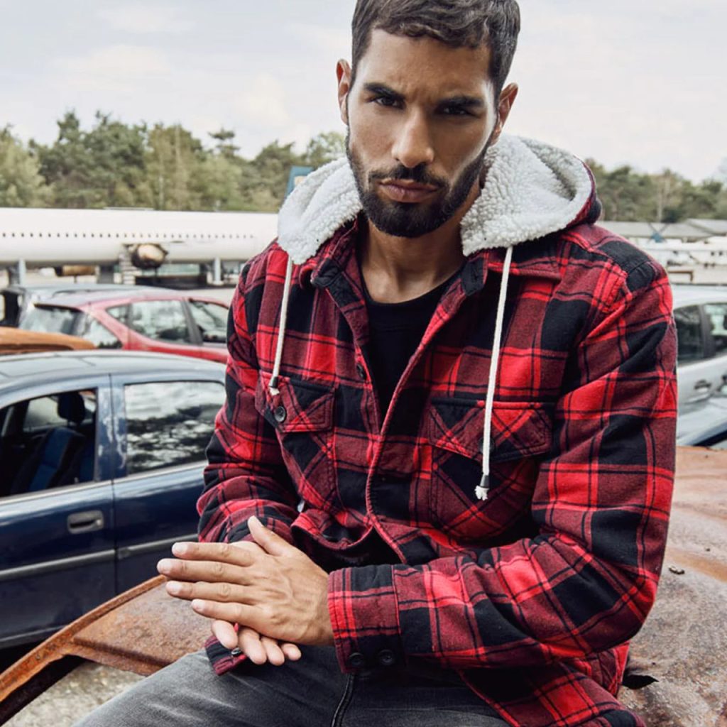 A man wearing black and red checkered Hooded Flannel Jacket